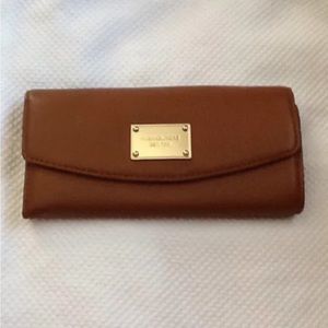 Michael Kors Brown Pebbled Leather Jet Set Flap Wallet.